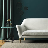 Sofa covered in a white velvet upholstery fabric