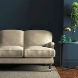 Sofa covered in a cream velvet upholstery fabric