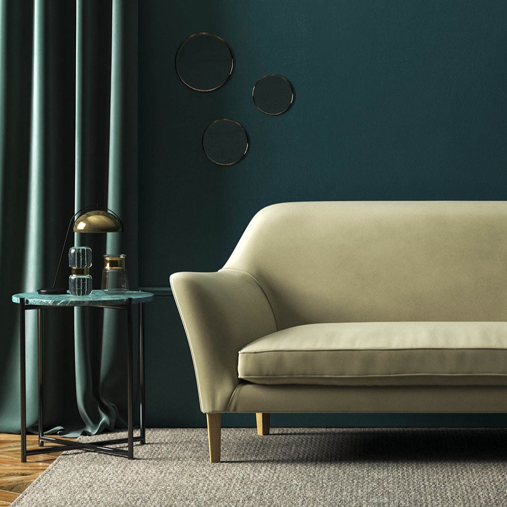 Sofa covered in a cream velvet upholstery fabric