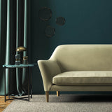 Sofa covered in a cream velvet upholstery fabric