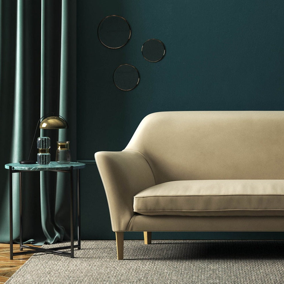 Sofa covered in a brown velvet upholstery fabric