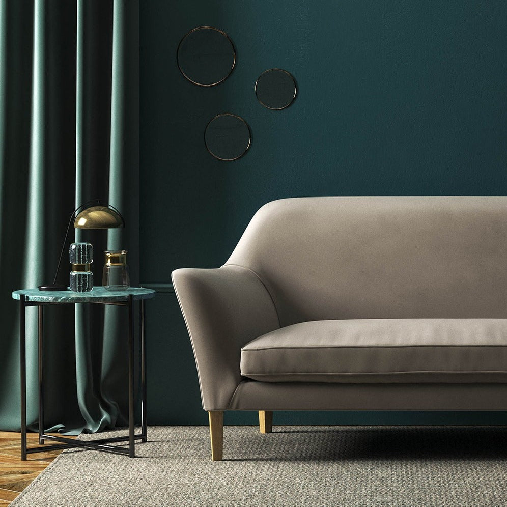 Sofa covered in a grey velvet upholstery fabric