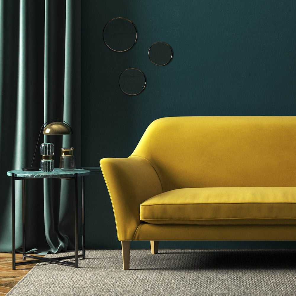 Sofa covered in a yellow velvet upholstery fabric