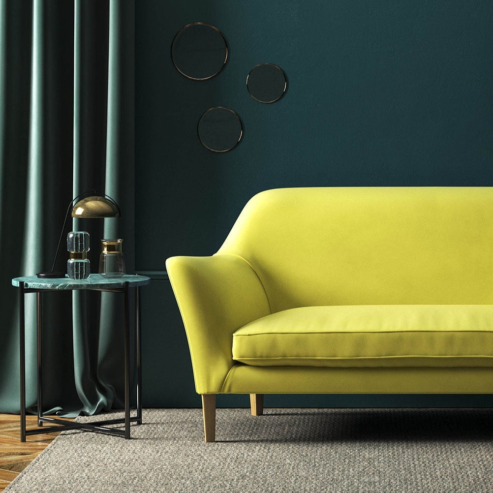 Sofa covered in a yellow velvet upholstery fabric
