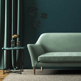 Sofa covered in a blue velvet upholstery fabric