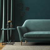Sofa covered in a blue velvet upholstery fabric