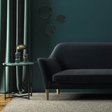 Sofa covered in a blue velvet upholstery fabric