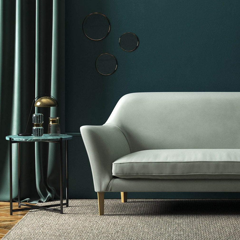 Sofa covered in a grey velvet upholstery fabric