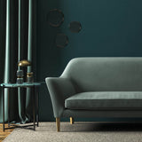 Sofa covered in a blue velvet upholstery fabric