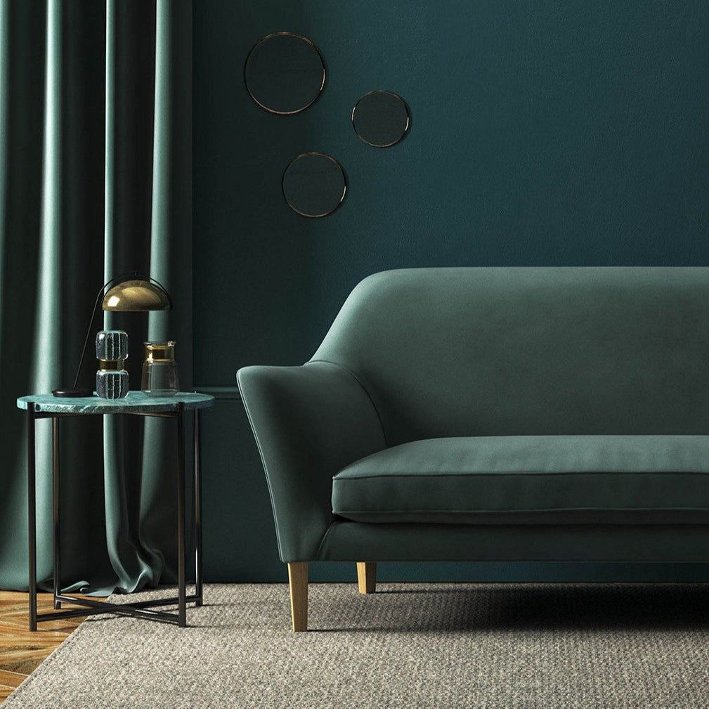 Sofa covered in a grey velvet upholstery fabric