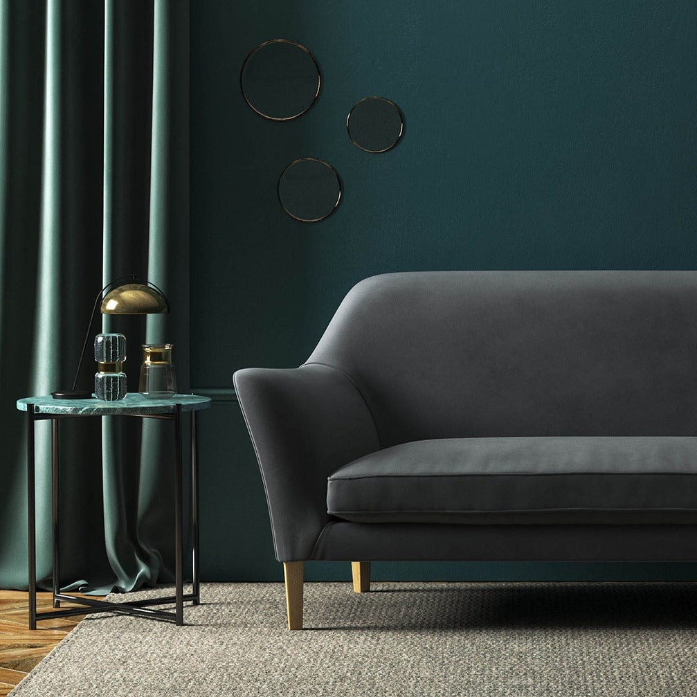Sofa covered in a grey velvet upholstery fabric