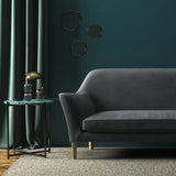 Sofa covered in a grey velvet upholstery fabric