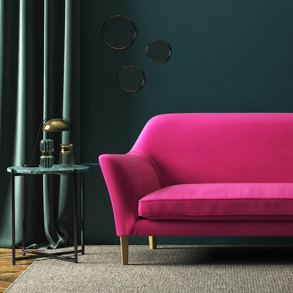 Sofa covered in a pink velvet upholstery fabric
