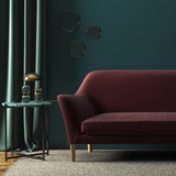 Sofa covered in a brown velvet upholstery fabric