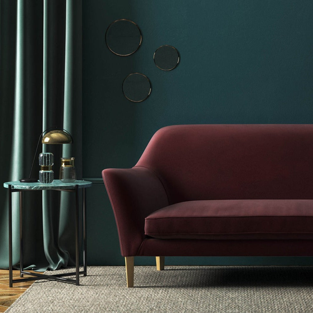 Sofa covered in a brown velvet upholstery fabric