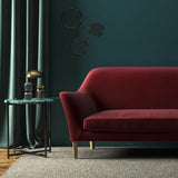 Sofa covered in a red velvet upholstery fabric