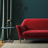 Sofa covered in a red velvet upholstery fabric