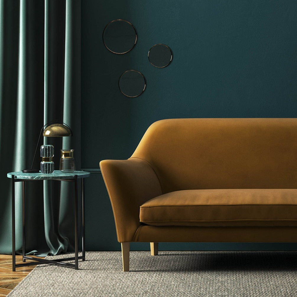 Sofa covered in a brown velvet upholstery fabric