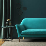 Sofa covered in a blue velvet upholstery fabric