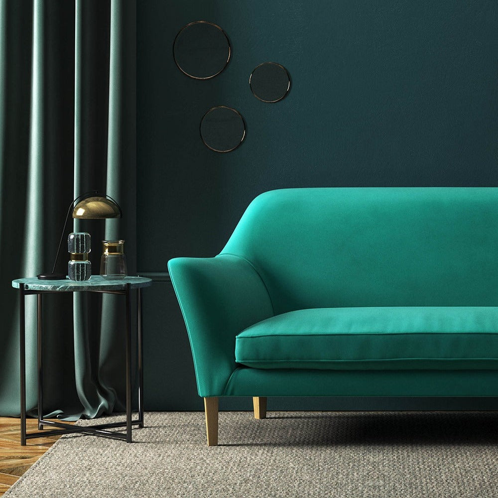 Sofa covered in a blue velvet upholstery fabric