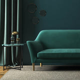 Sofa covered in a blue velvet upholstery fabric