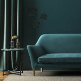 Sofa covered in a blue velvet upholstery fabric