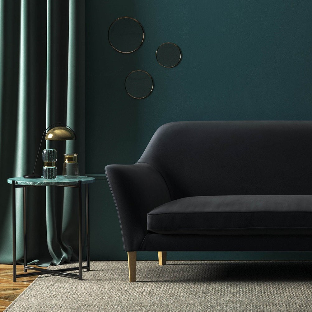 Sofa covered in a navy velvet upholstery fabric
