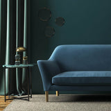 Sofa covered in a blue velvet upholstery fabric