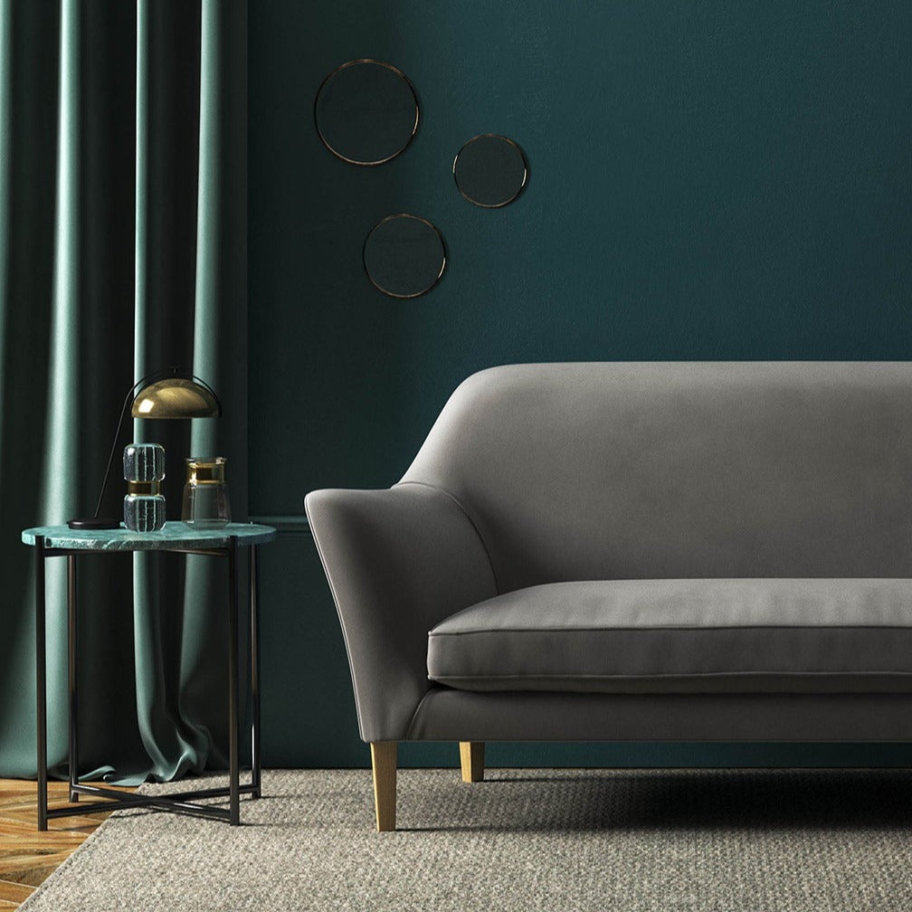 Sofa covered in a grey velvet upholstery fabric