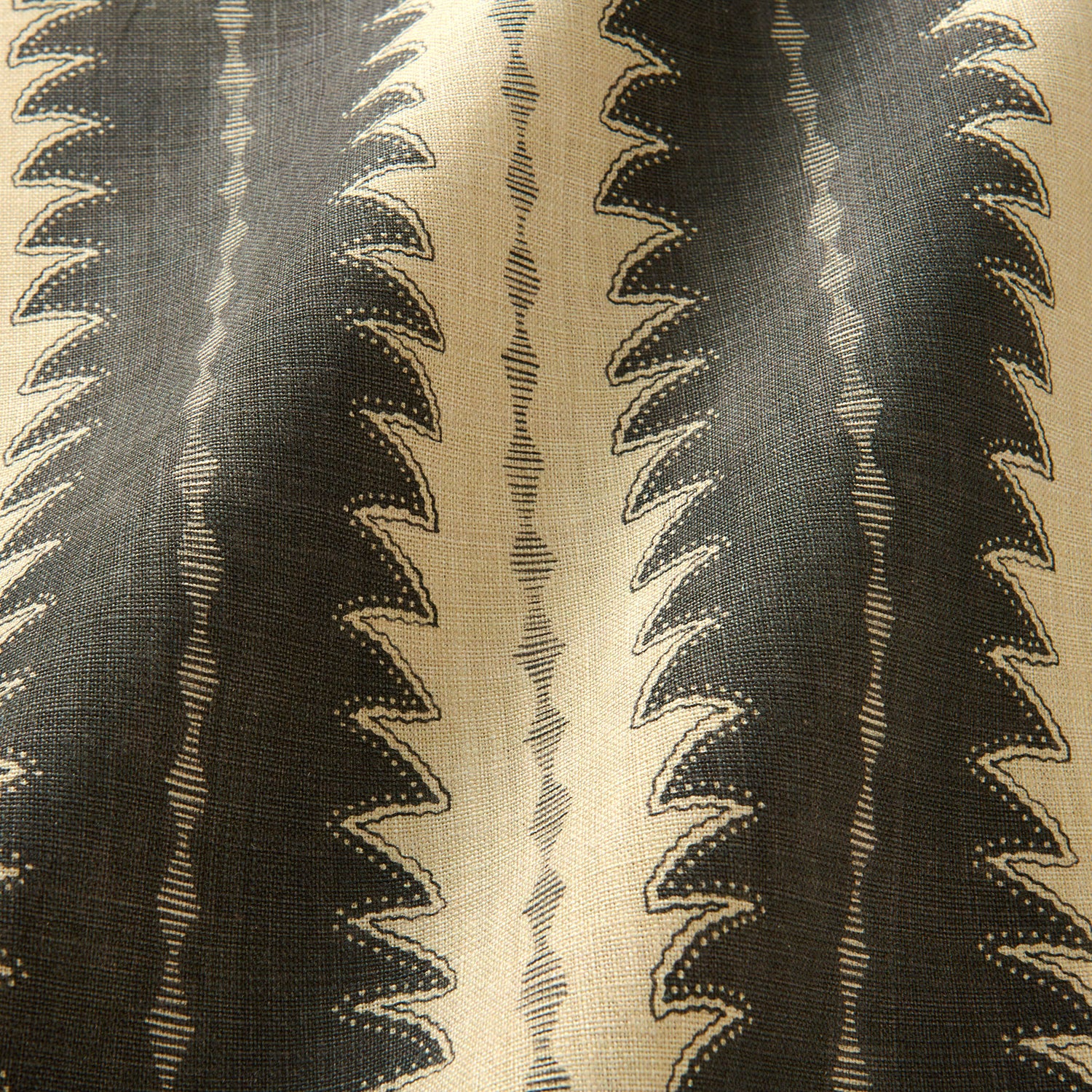 A printed linen fabric sample in black and off white featuring a striped fern