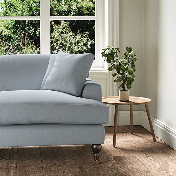 A powder blue, woven fabric on an armchair.